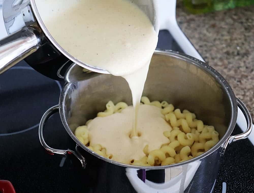 Pour cheese sauce over pasta