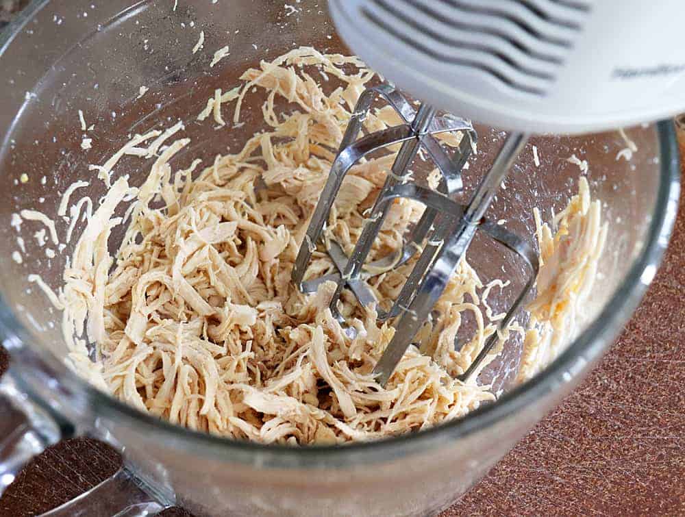 Shredding poached chicken with a hand mixer