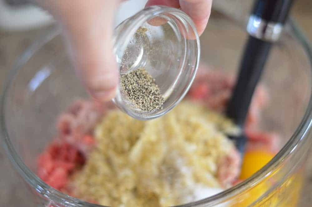 Adding pepper to the meat mixture