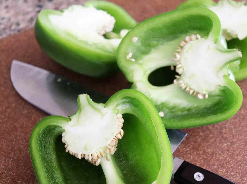 Slicing green peppers in half