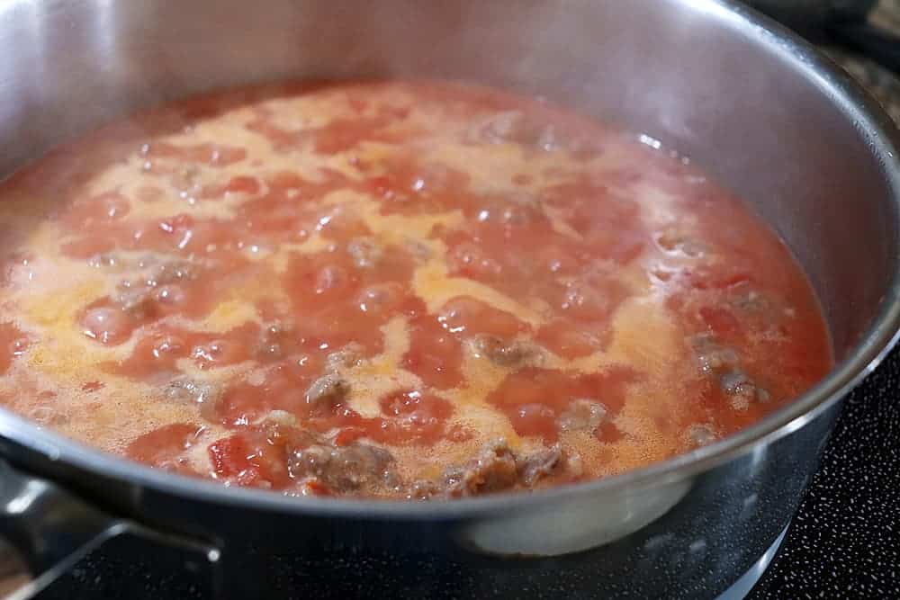 Reducing the tomatoes for the Penne With Sausage and Tomato Cream Sauce