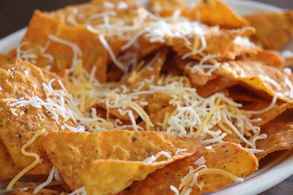 Sweet Spicy Doritos topped with shredded Mexican cheese