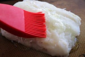 Brushing cod with oil