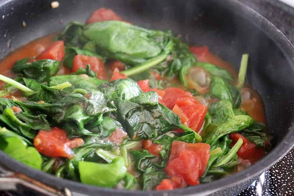 Sauteing spinach and tomatoes