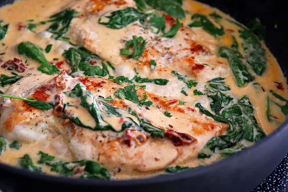 Finish cooking the chicken in the sauce for Creamy Tuscan Chicken Recipe