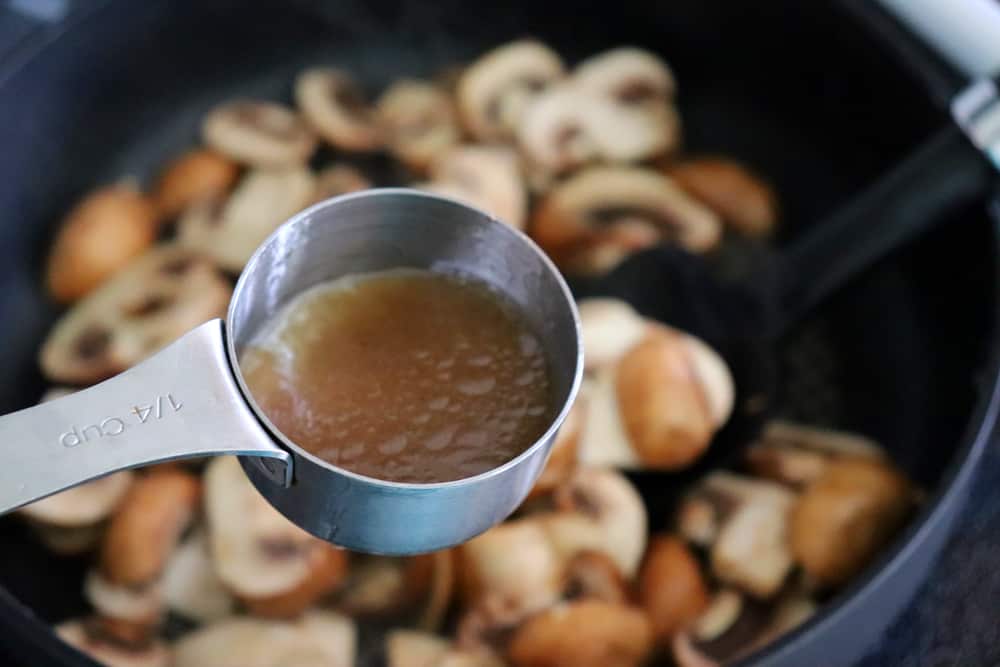 Cooking the mushrooms in broth
