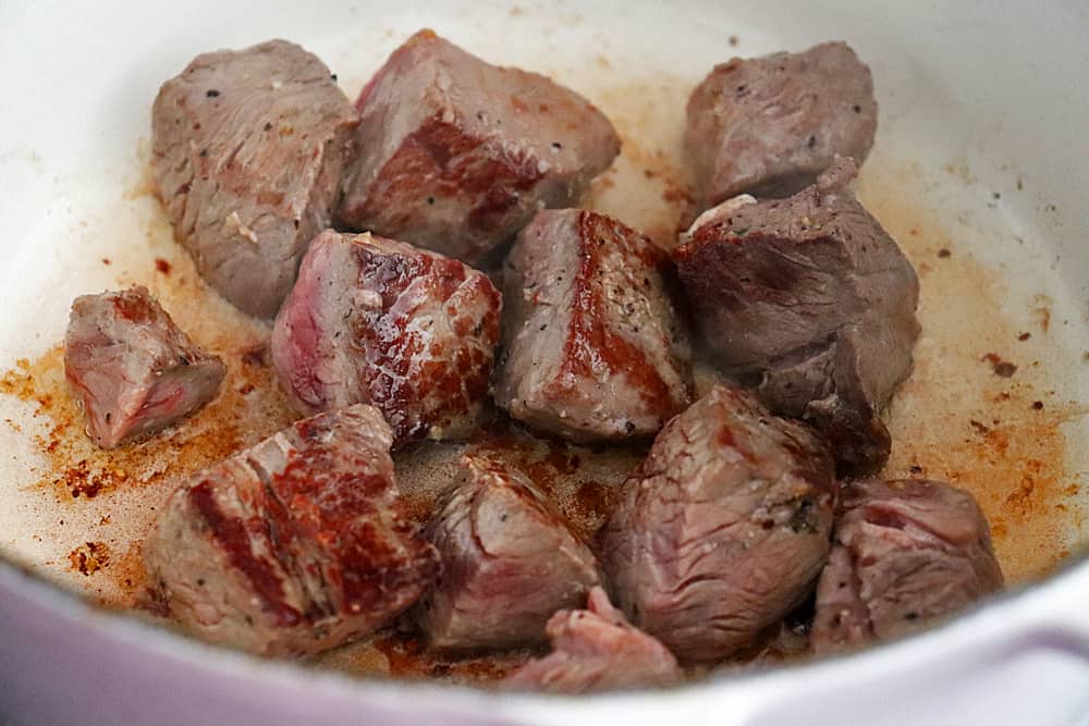 Browned steak bites in the pan (par-cooked)