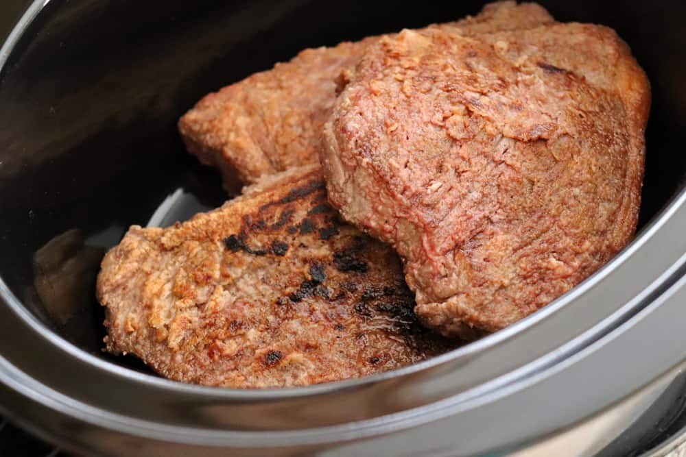 Add browned meat to slow cooker