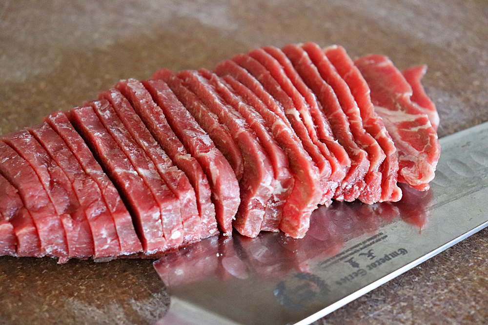 Slice semi-frozen steak